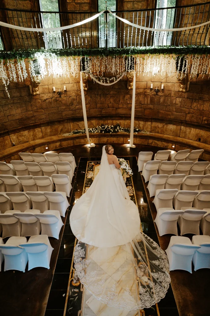 Bride standing in the aisle inside the cathedral chapel